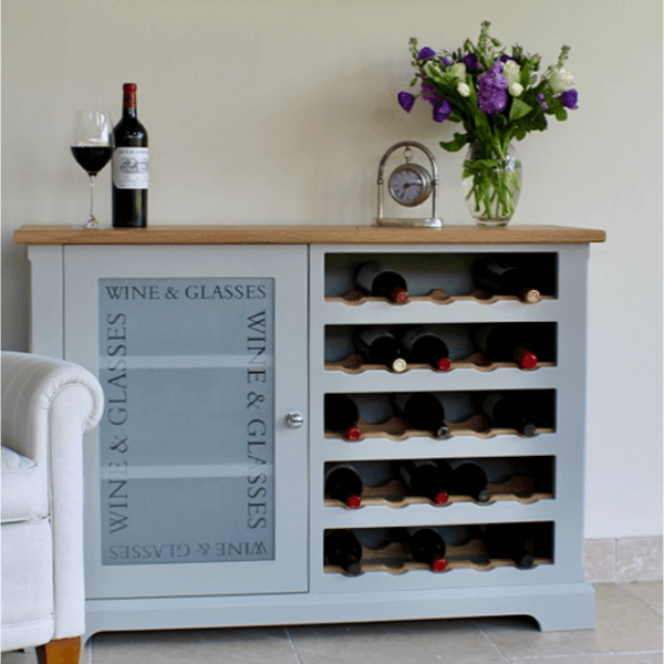 Floor standing unit with one side being an open wine rack with oak bottle accents, and the other being a glazed cupboard for glasses storage etched with the words wine and glasses